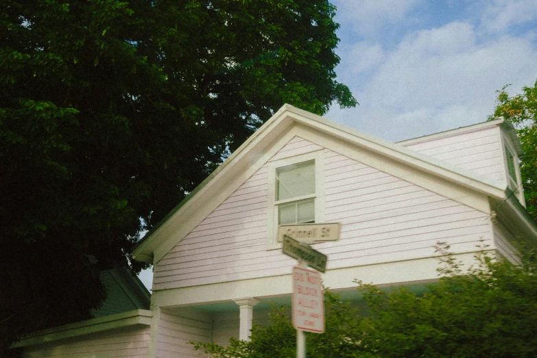 a street sign is shown in front of the house