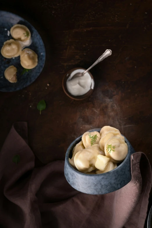 some food in a metal bowl with spoon next to it