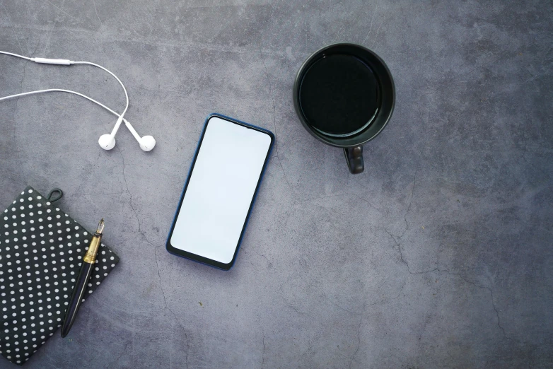 an mp3 player, cellphone, neck tie, and pen are on the floor