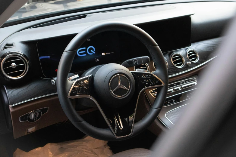 a mercedes dashboard with blue ons, controls and steering wheel