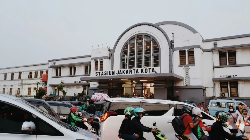 a group of people on bicycles moving past a building