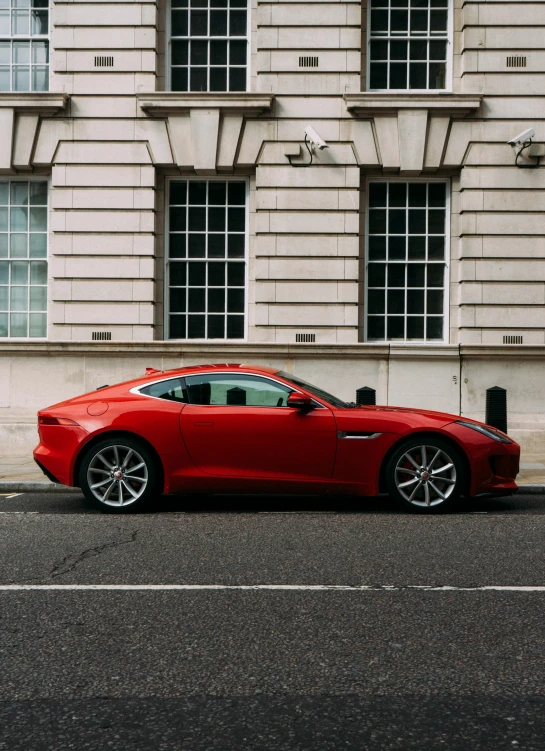 a red sports car parked on the side of the road