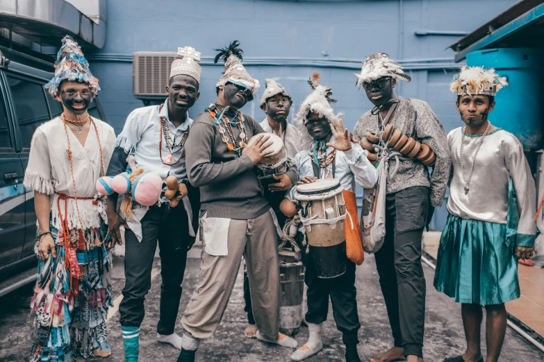 there are people standing together and holding some items