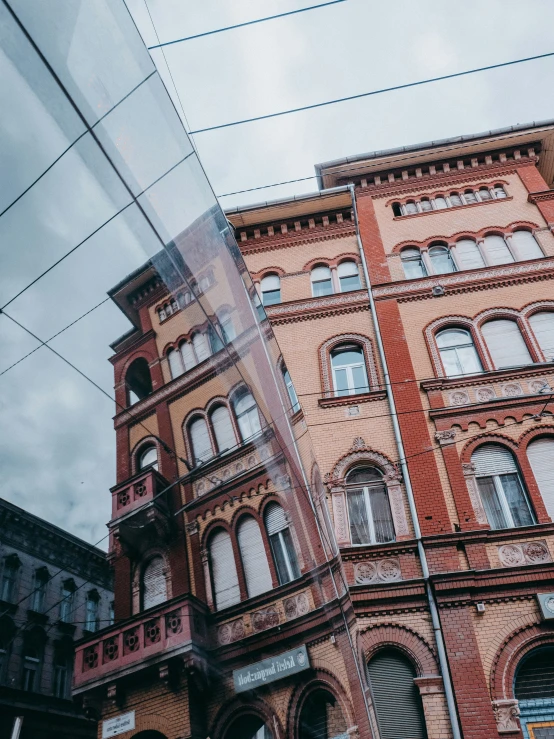 the red brick buildings are in front of a wire