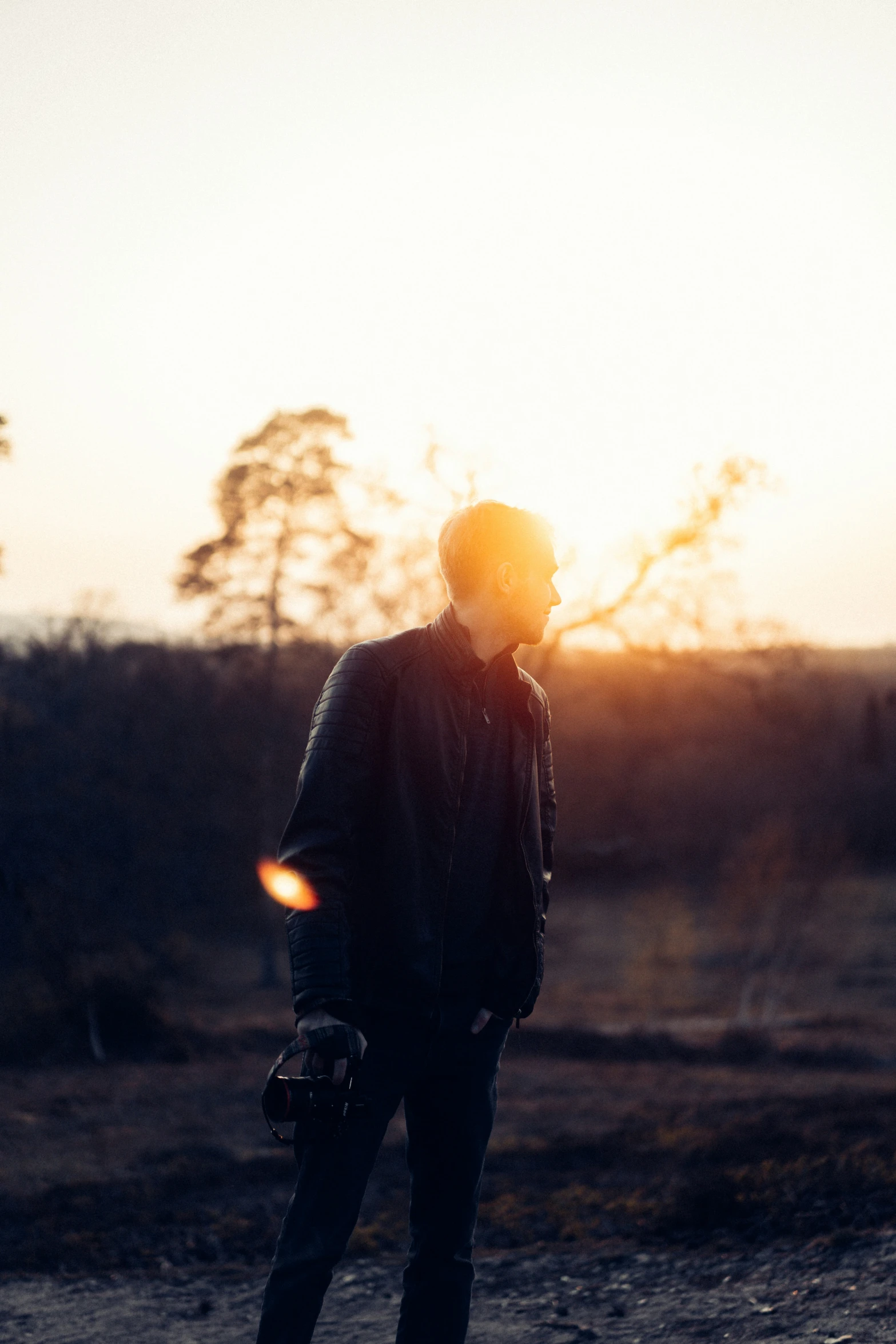 a man is standing in the evening in a field