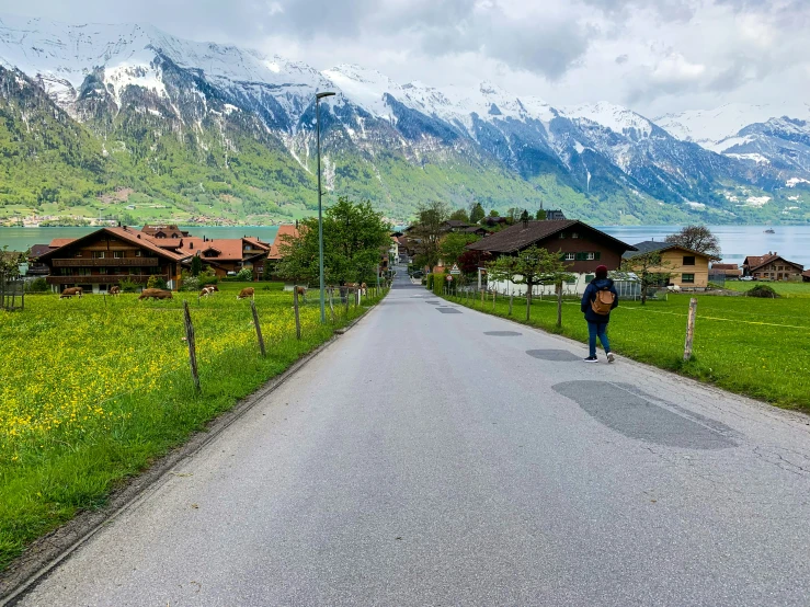 two people walking down a path in the mountains