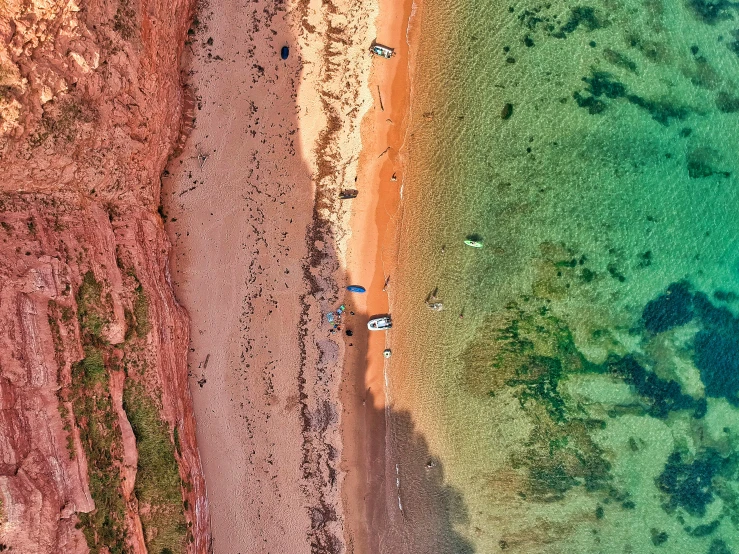 an aerial s of some colorful beach, green water and blue skies