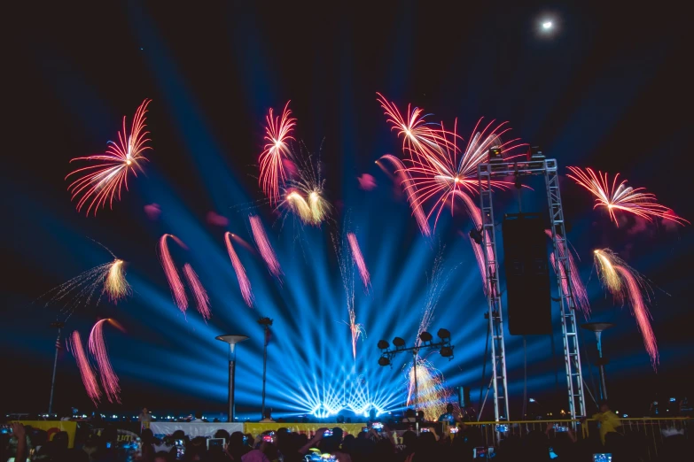 fireworks are exploding at the night sky over a street