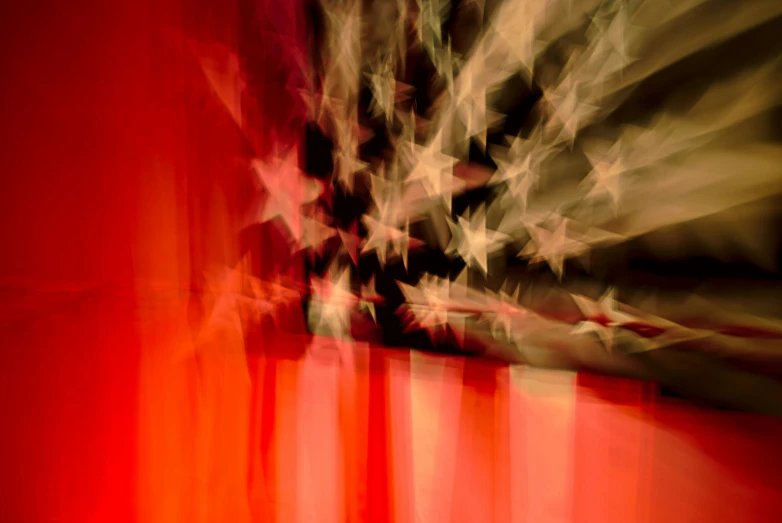 a blurred american flag is seen on a wall