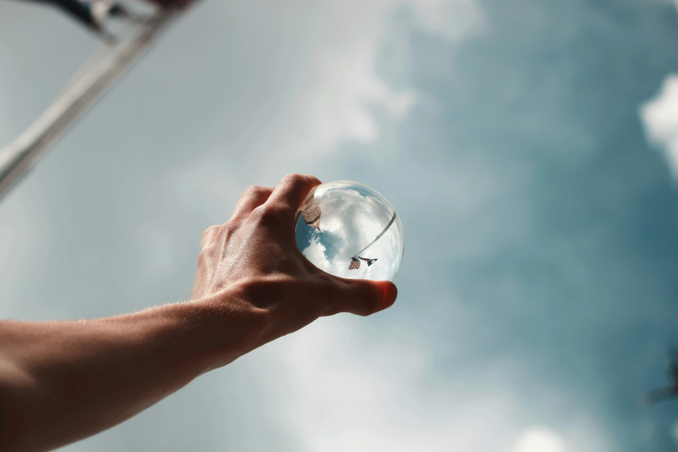 a hand holding an object up in the air