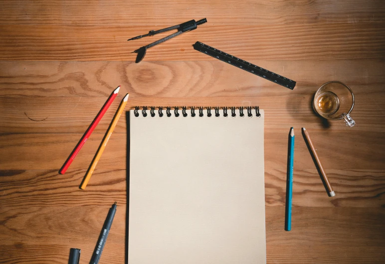 an open notebook on top of a wooden table