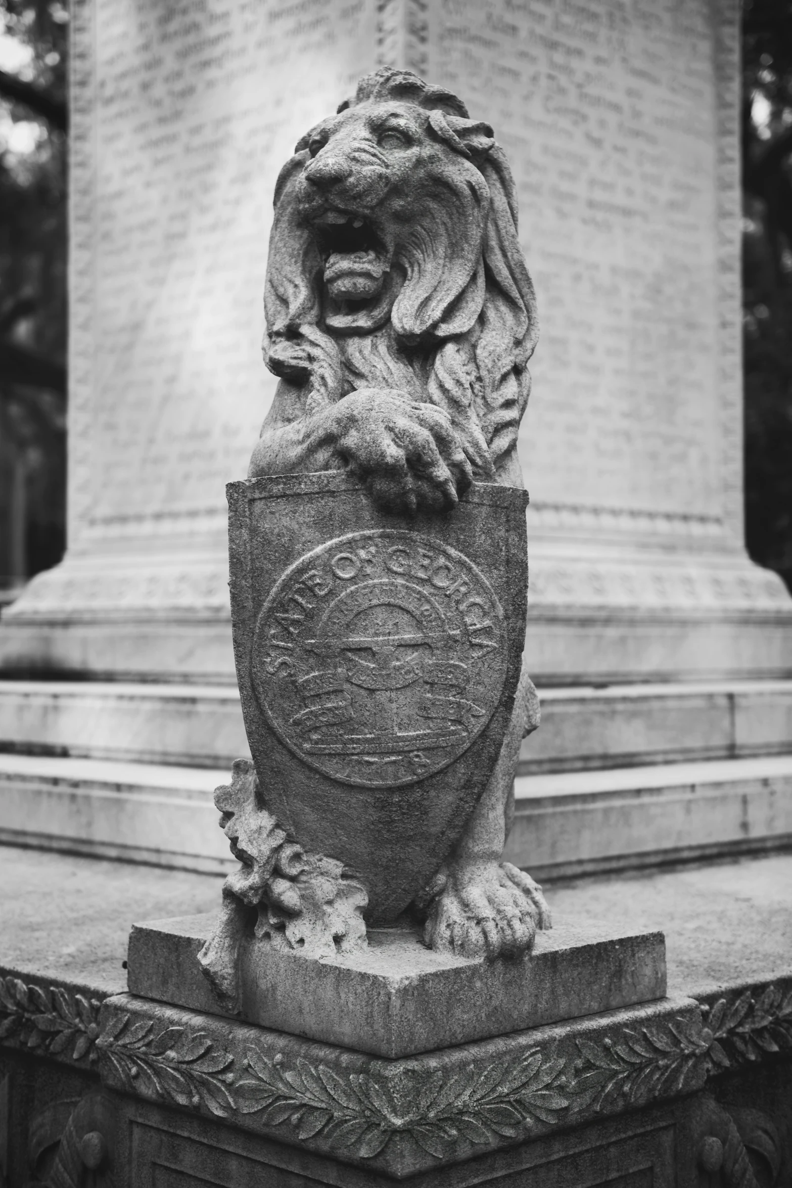 the statue of a lion sits in front of a cemetery