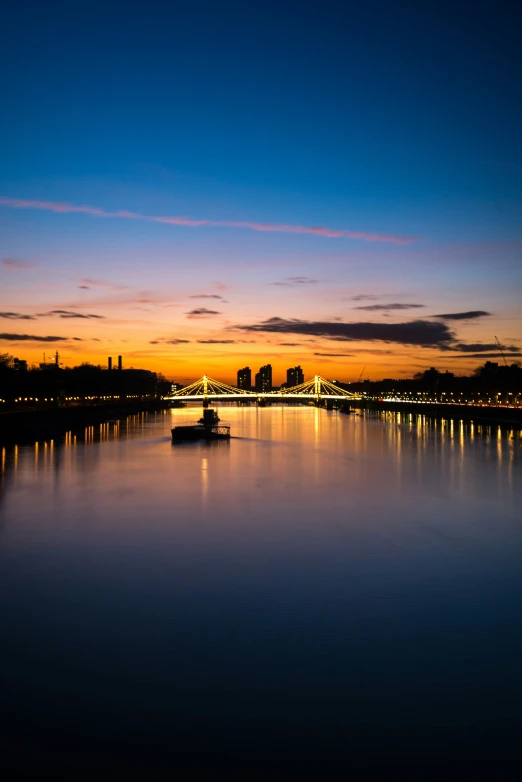 a small boat sits on the water at night