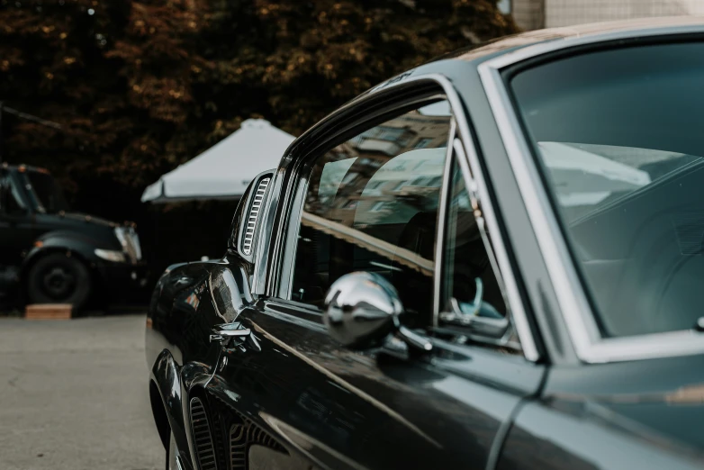 the front side of a blue car with an open window