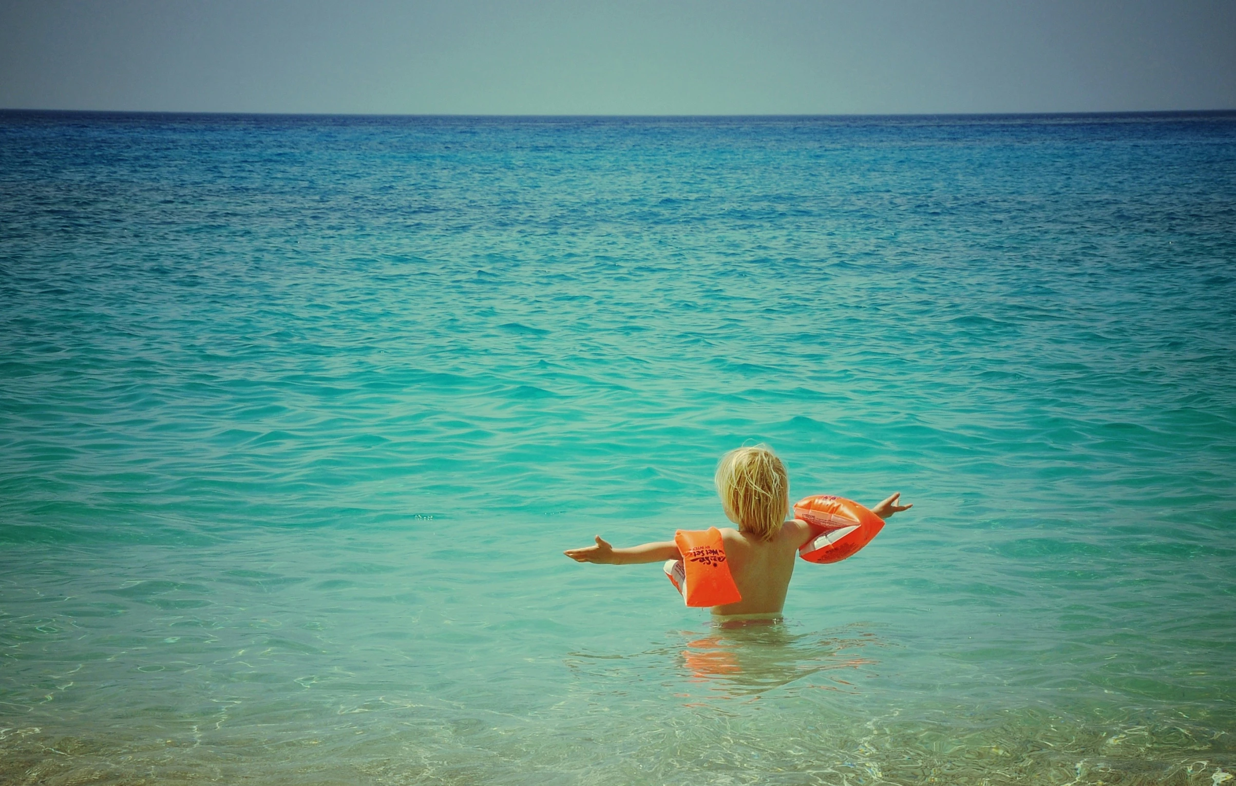 a  plays with an inflatable ball in the ocean