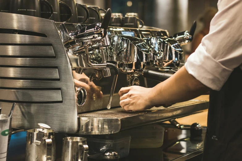 the espresso machine is filled with drinks that are kept on the counter