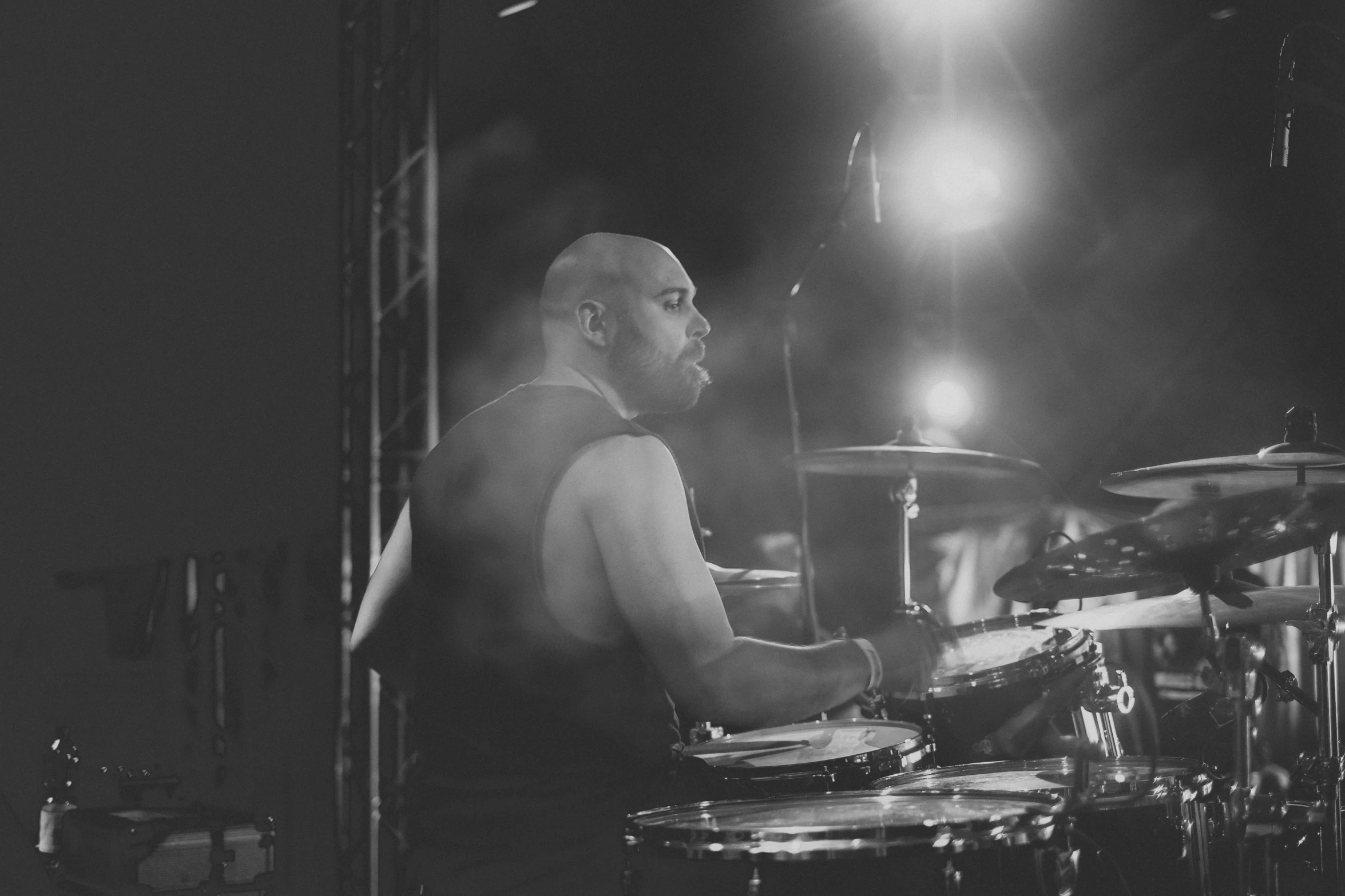 a man sitting at a drum set in front of microphones