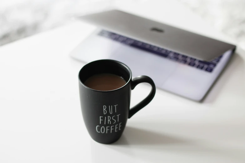 a coffee mug is shown sitting next to a tablet