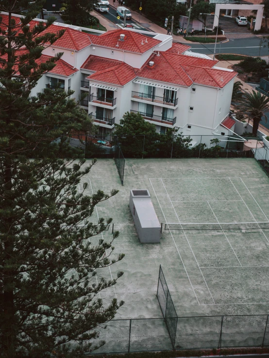 a tennis court surrounded by many buildings