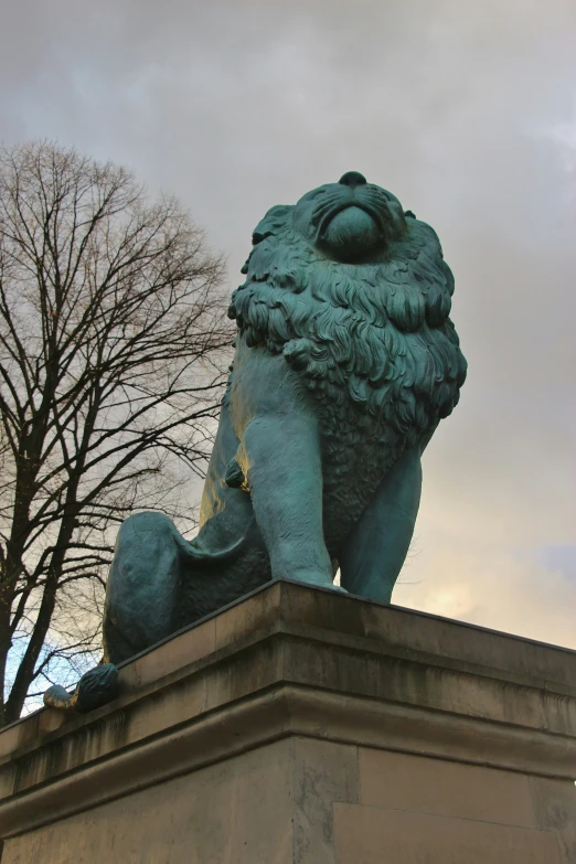 a sculpture of a lion holding the tail of a human