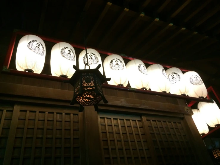 a chinese lantern with several lit up lanterns above