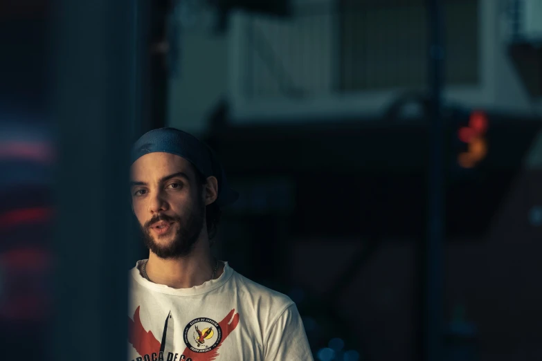 a man in white shirt standing next to a street