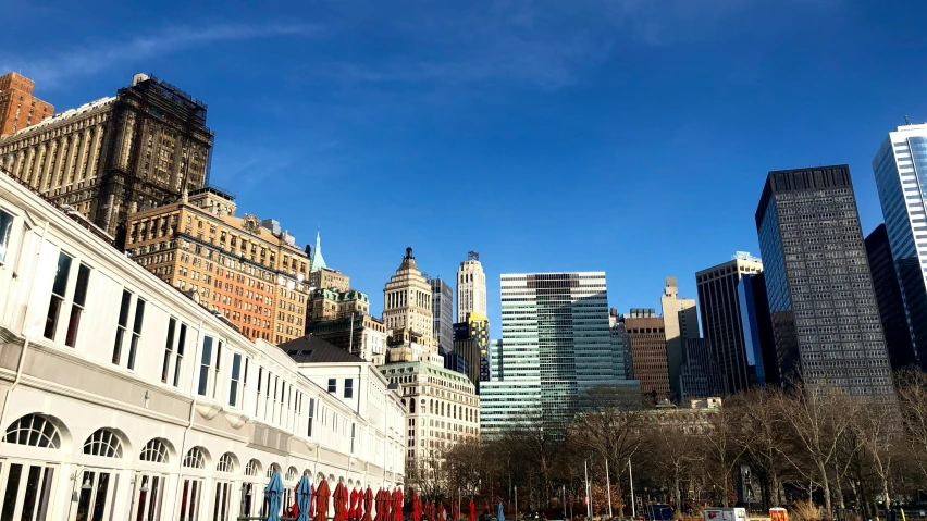 tall buildings stand near a path in the city