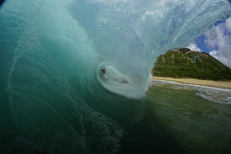 a person inside a wave with one foot up in the water