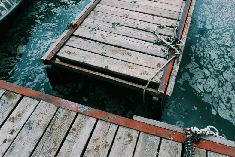 a boat tied to a dock with a rope