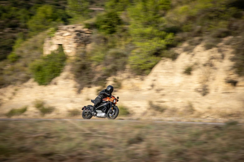 a man riding a motorcycle on the side of a road