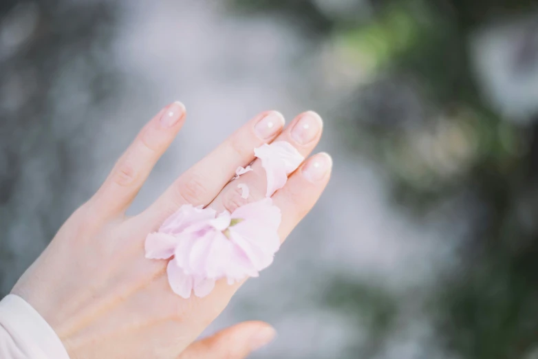 a woman's hand holding onto her flowers