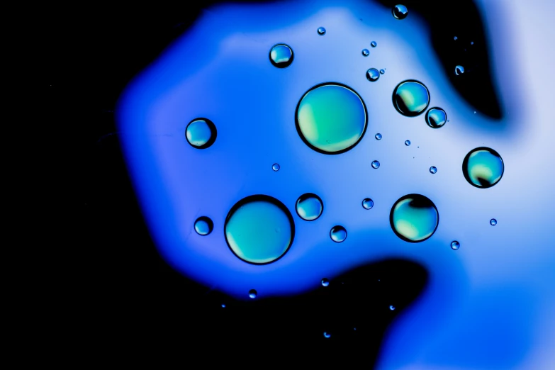 blue bubbles are coming out of a liquid bottle