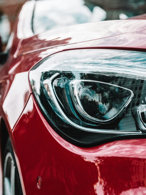 a close up of a red car headlight on the car