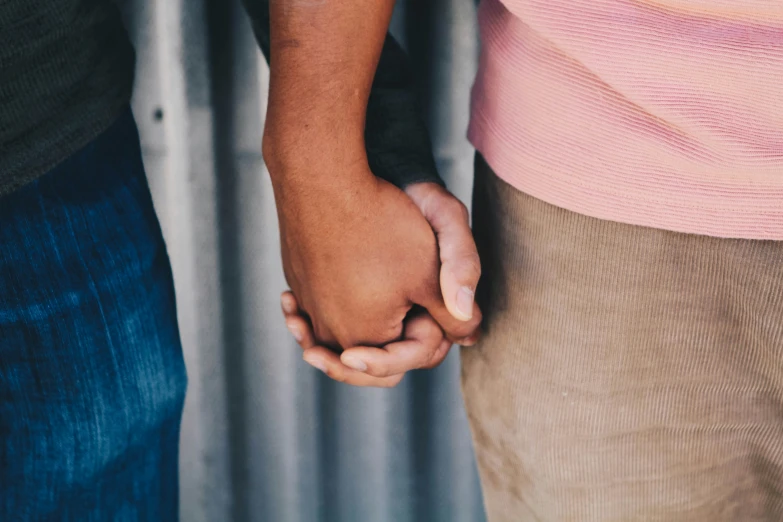 a close - up of two hands holding each other