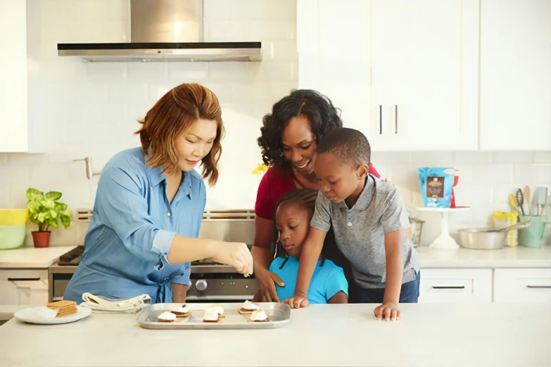 woman, children, and adult preparing desserts in kitchen