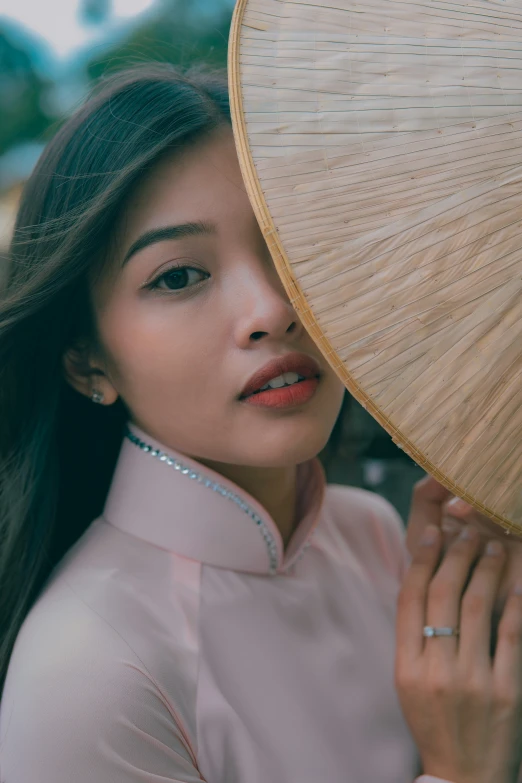 a woman holding an umbrella up to her face