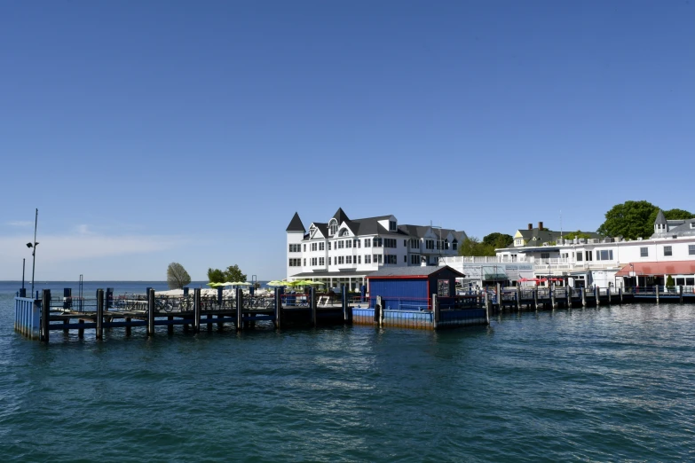 an island sits behind the ocean and houses on each end