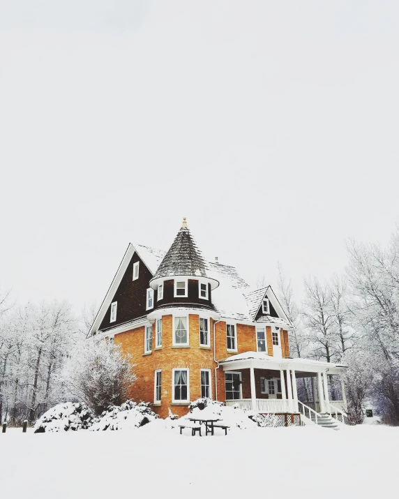 a large red house is surrounded by snow