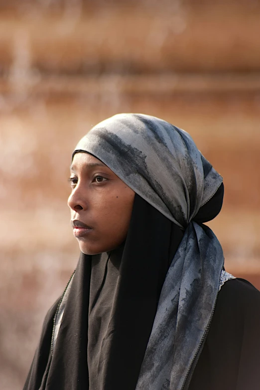 an image of a woman with a headscarf looking off