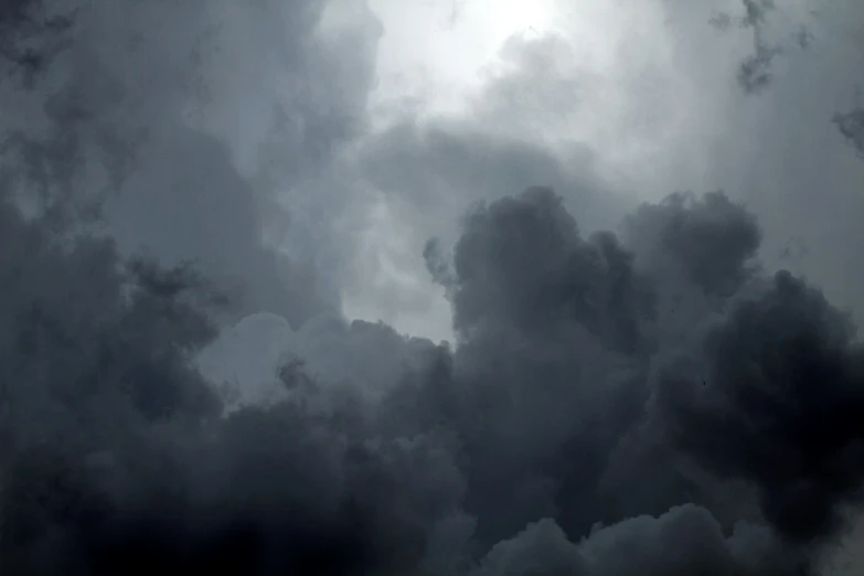 a plane flies through an ominous sky filled with dark clouds