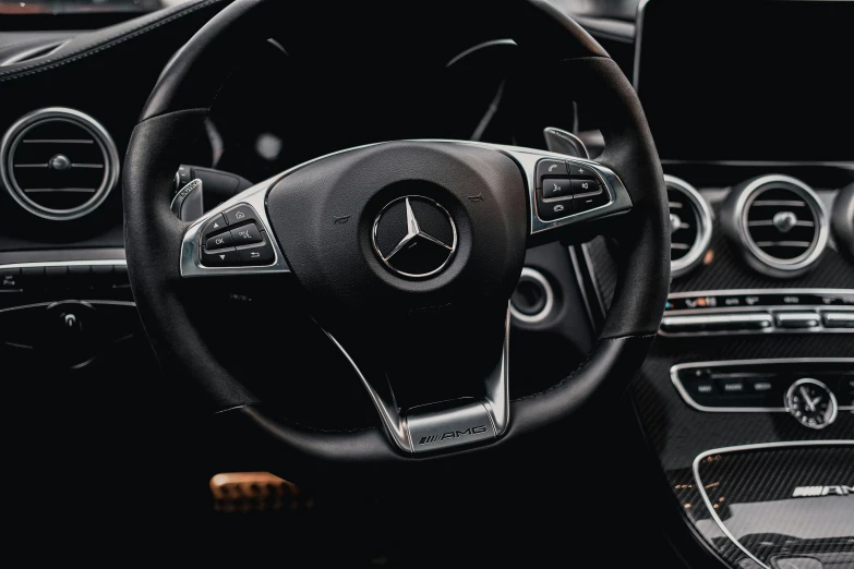 inside view of a car steering wheel and dashboard