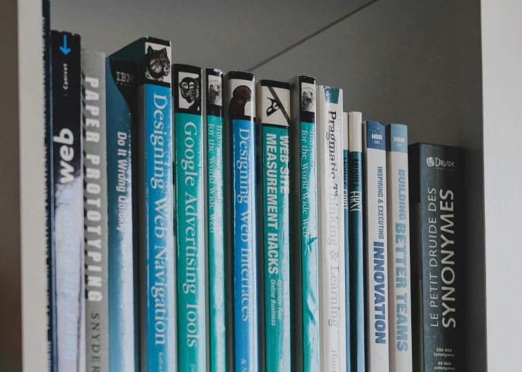 a close up of several books on a shelf