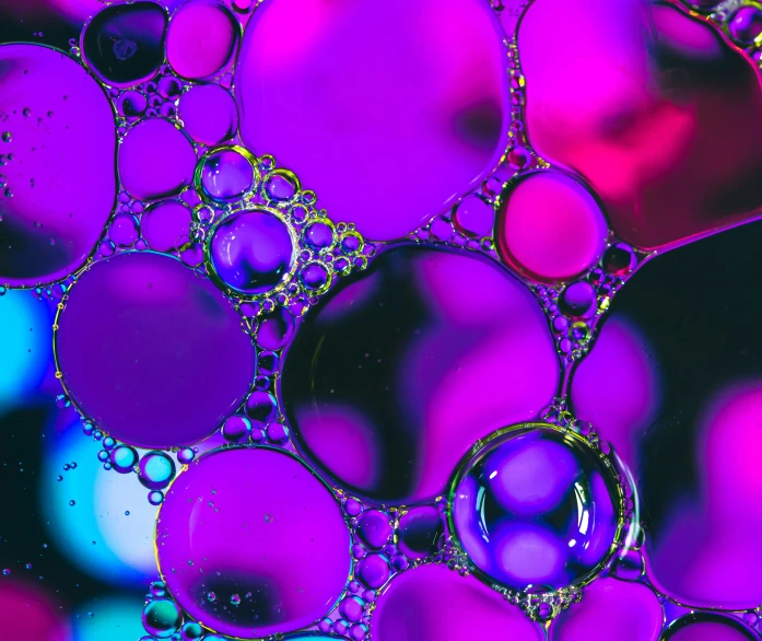 closeup of purple bubbles in a blue and green water