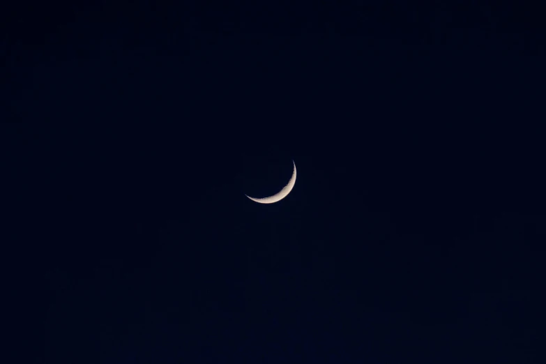 a crescent moon with a half - moon in the background