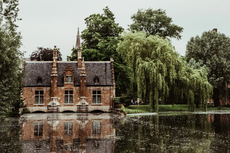 an image of water house and trees reflected in the water