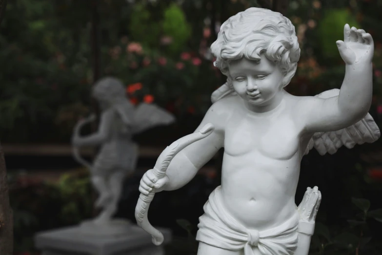 this little angel statue is looking like he has his hands in the air