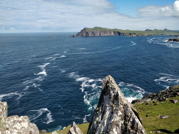 the rocks in front of the water are surrounded by waves