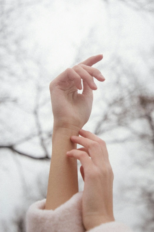 two people reaching for soing very high up in the sky