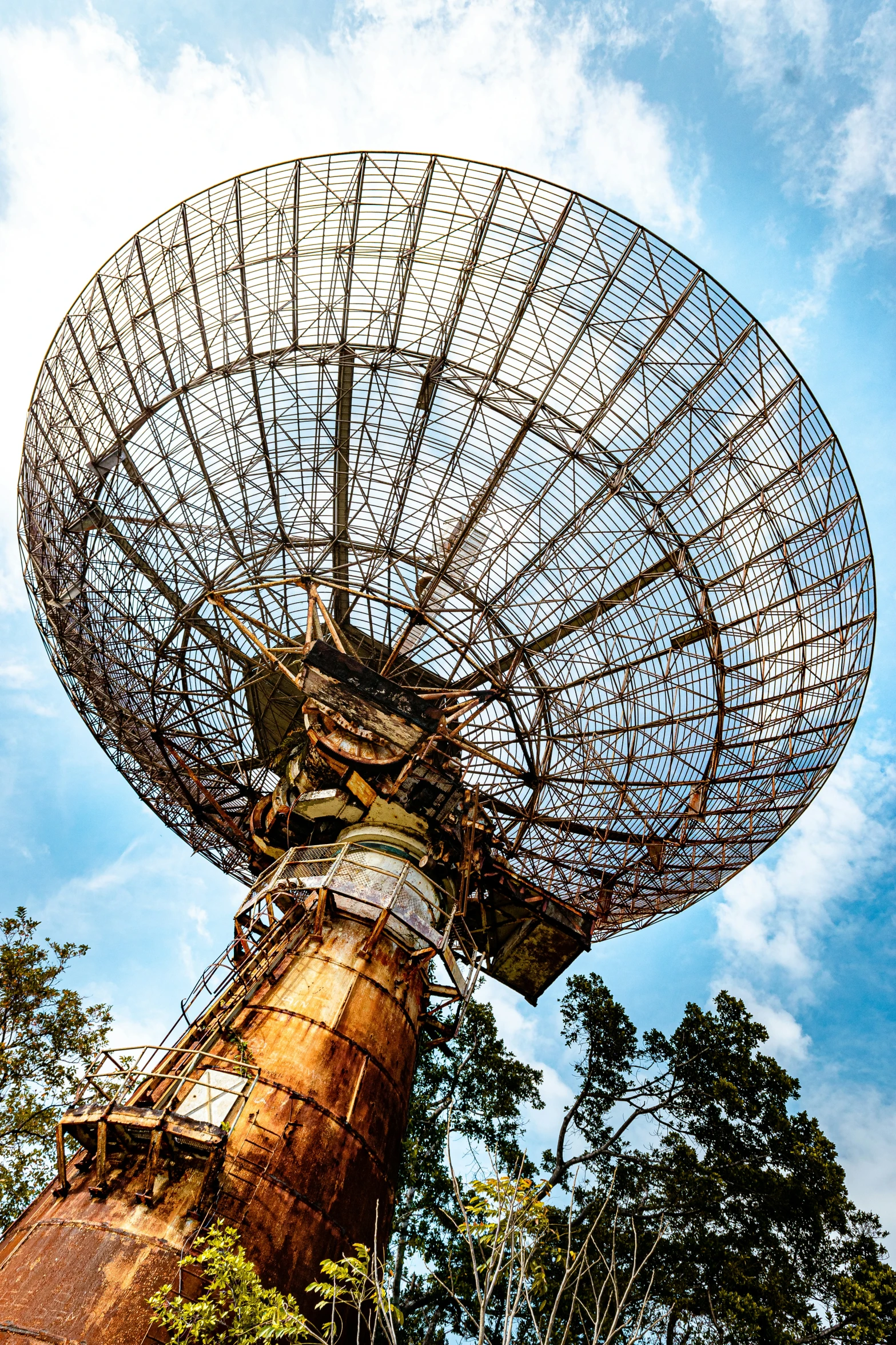 an old antenna sitting atop top of trees