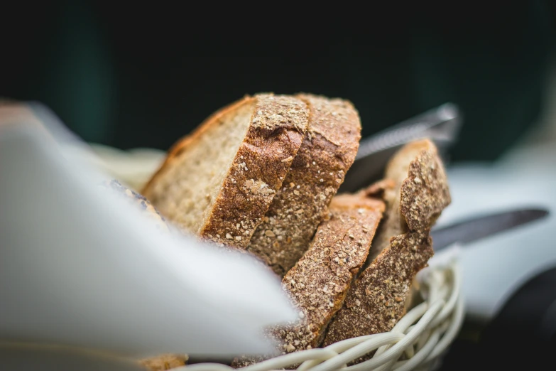 a white basket filled with slices of bread